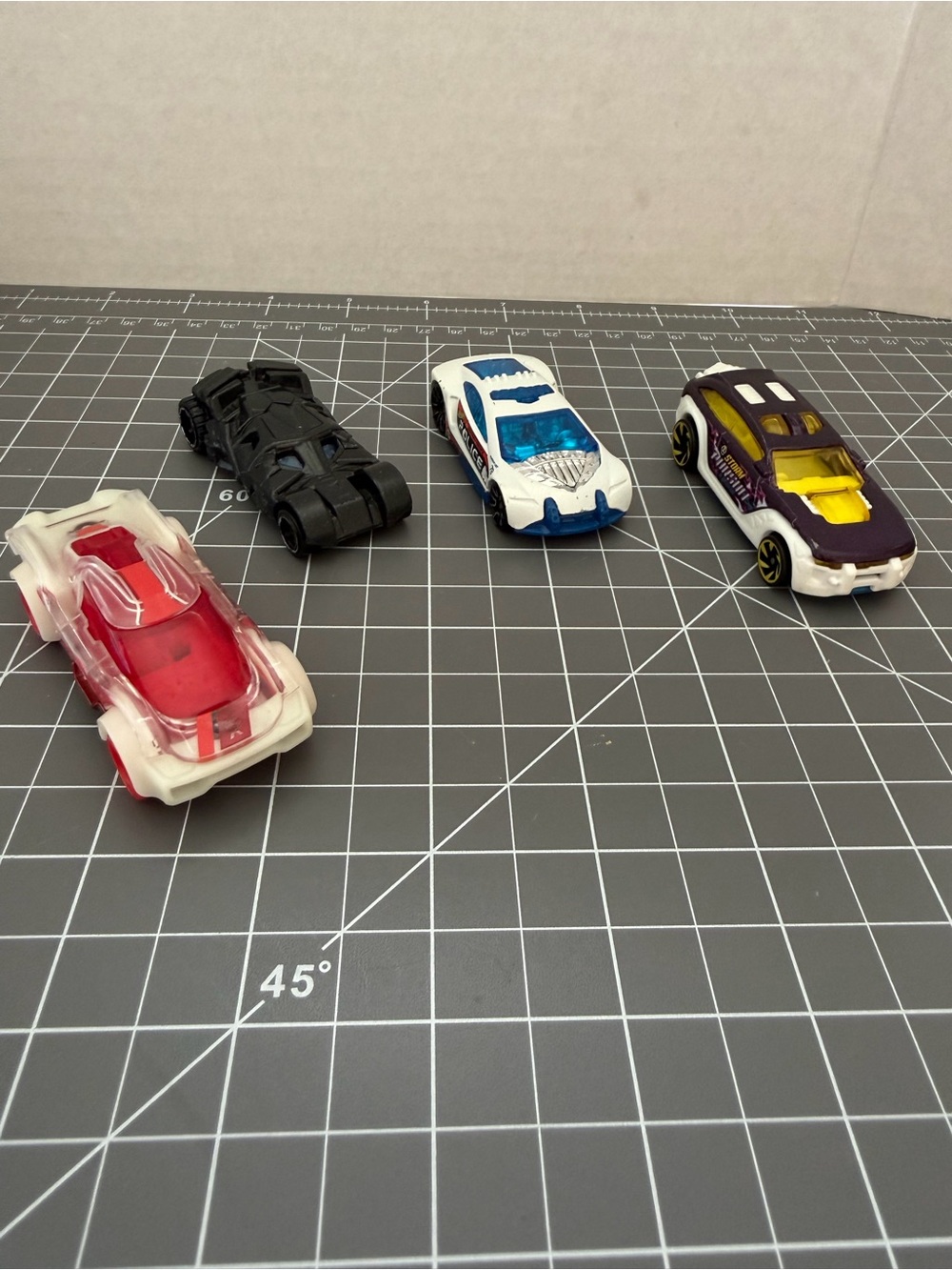 Hot wheels lot of 4 cars. Batmobile. Storm Pursuit. Police. Cosmic Coupe